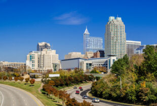 Raleigh downtown skyline and street lined with Autumn colored trees